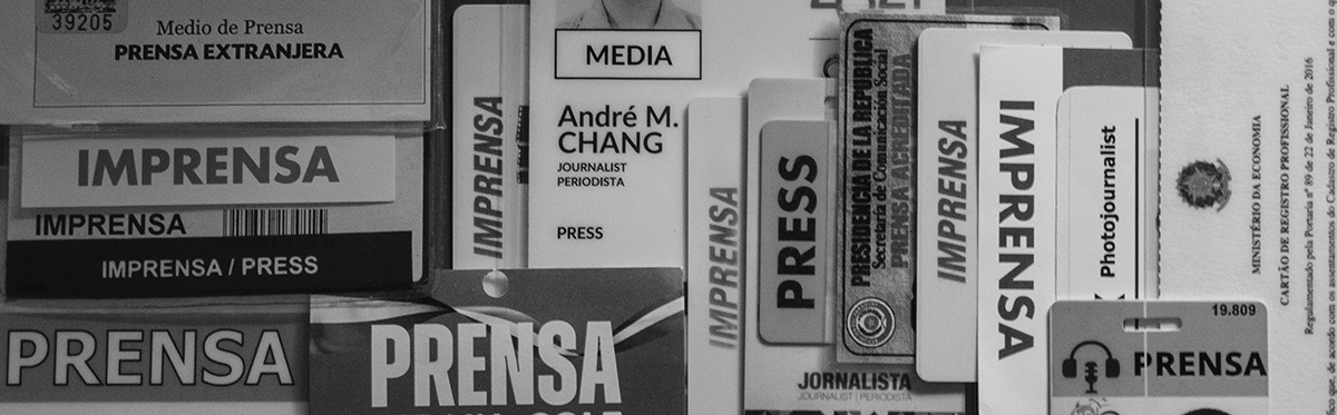 Black and white cropped image of a collection of press credentials