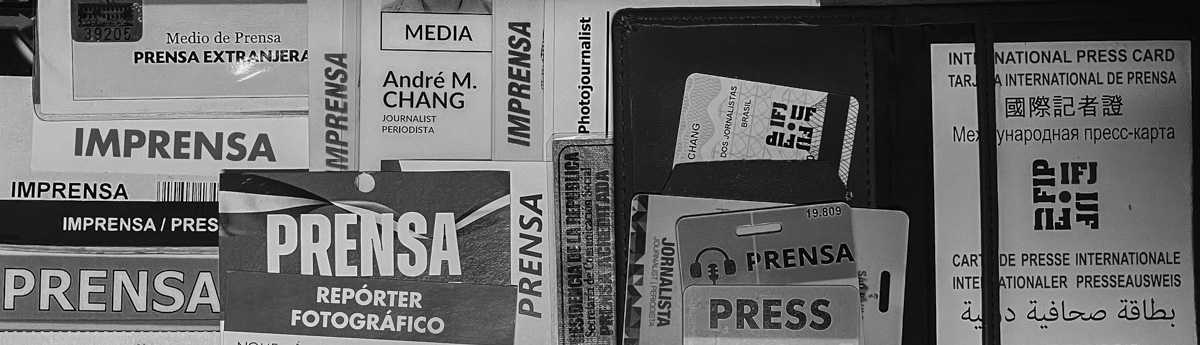 black and white cropped image of a collection of press credentials